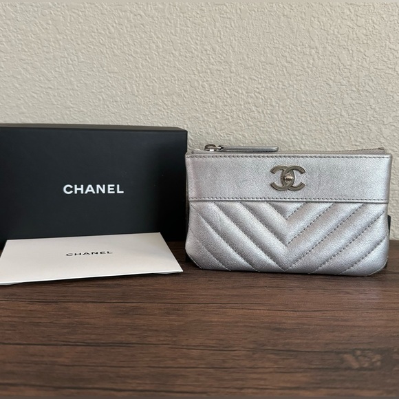 CHANEL Handbags - CHANEL Metallic Silver Chevron Quilted Leather Pouch